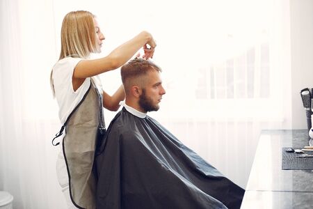 Stylish man sitting in a barbershopの写真素材