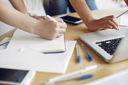 Students create a new project. Two girls working at the office