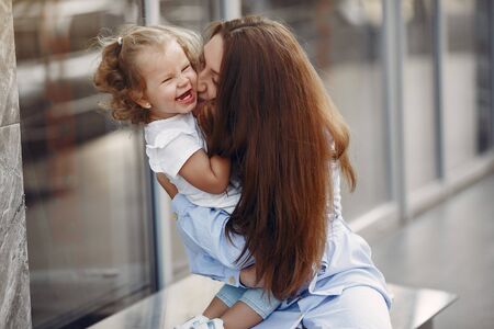 Mother with daughter playing in a summer cityの写真素材
