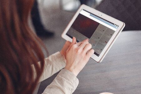 Businesswoman sitting at the table with a tablet