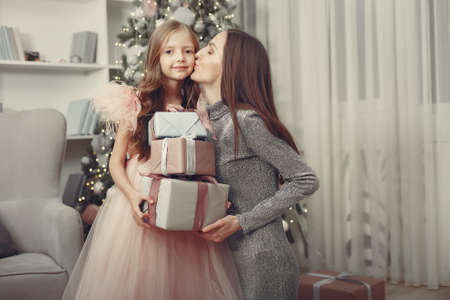 Little girl near christmas tree in a pink dressの写真素材