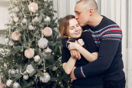 Couple spend time at home with christmas decorations