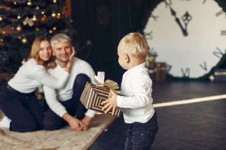 Family with little son at home near christmas treeの写真素材