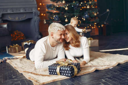 Family with little son at home near christmas treeの写真素材