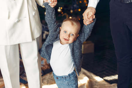 Family with little son at home near christmas tree