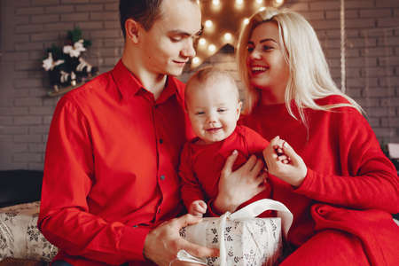 Family sitting at home on a bed