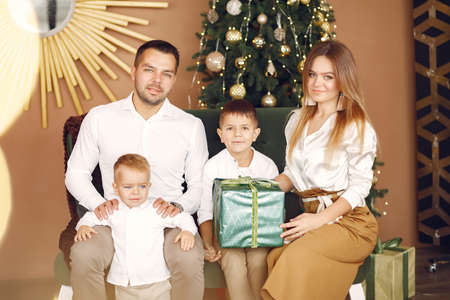 Family sitting at home near christmas treeの写真素材