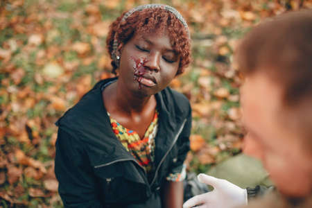 Man help a african girl with bleedingの写真素材