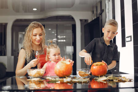 Family cuts pumpkins in the kitchenの写真素材