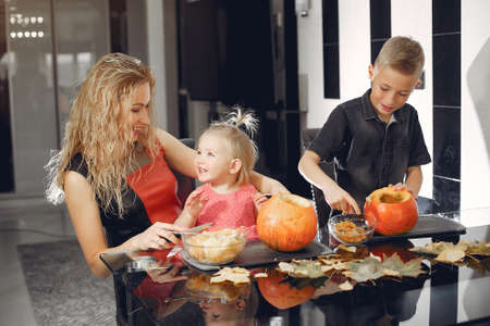Family cuts pumpkins in the kitchenの写真素材