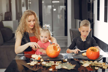 Family cuts pumpkins in the kitchenの写真素材