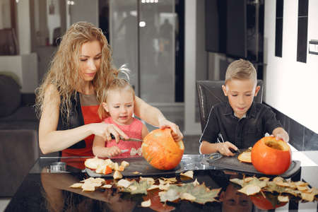 Family cuts pumpkins in the kitchenの写真素材