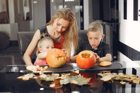 Family cuts pumpkins in the kitchenの写真素材