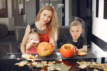 Family cuts pumpkins in the kitchenの写真素材