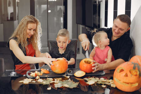 Family cuts pumpkins in the kitchenの写真素材