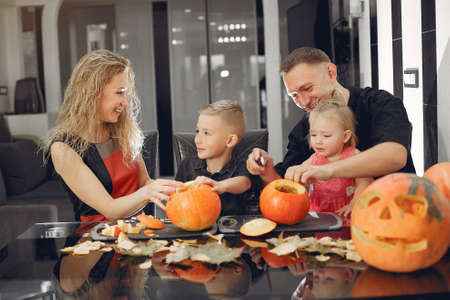 Family cuts pumpkins in the kitchenの写真素材
