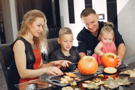 Family cuts pumpkins in the kitchenの写真素材