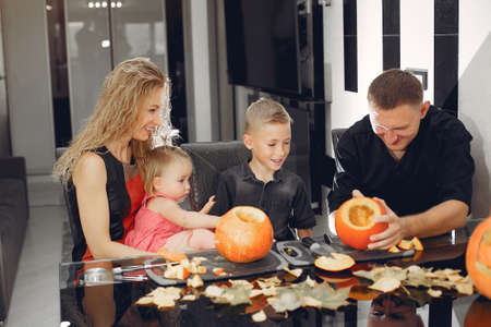 Family cuts pumpkins in the kitchenの写真素材