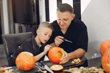 Family cuts pumpkins in the kitchenの写真素材