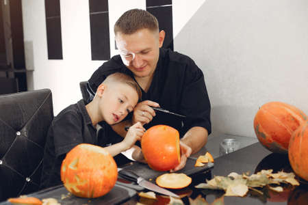 Family cuts pumpkins in the kitchenの写真素材