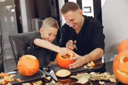 Family cuts pumpkins in the kitchenの写真素材