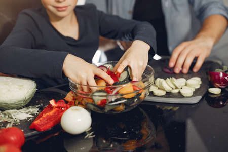 Cute family prepare food in a kitchen