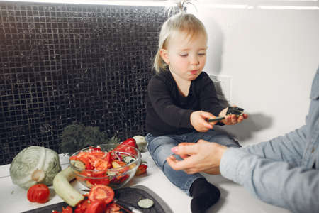 Beautiful family prepare food in a kitchenの写真素材