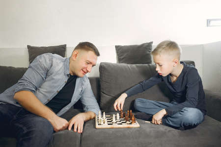 Father with son plays in a chessの写真素材