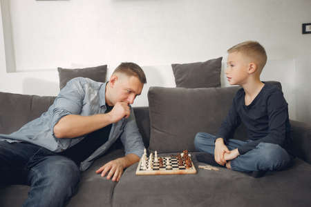 Father with son plays in a chessの写真素材