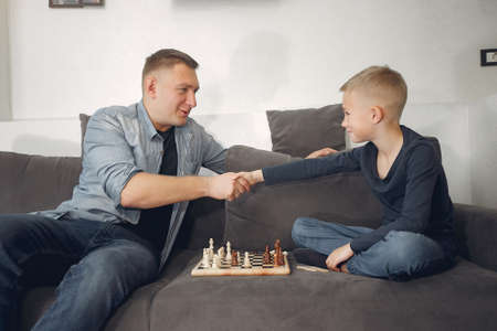 Father with son plays in a chessの写真素材