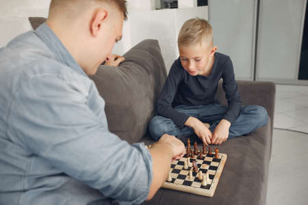 Father with son plays in a chessの写真素材