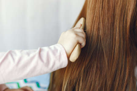 Mother and little daughter have fun at homeの写真素材