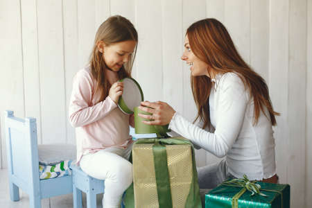 Mother and little daughter have fun at homeの写真素材