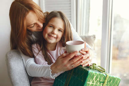 Family sitting at home with presents