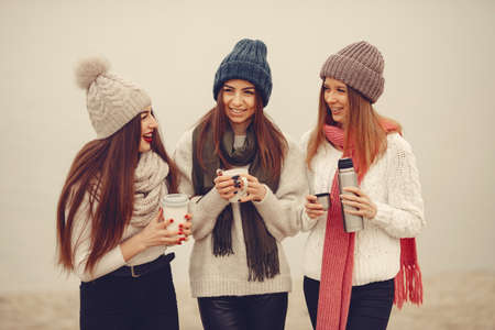 Women in a winter park without snow with bottle and teaの写真素材
