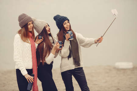 Women in a winter park without snow with bottle and teaの写真素材