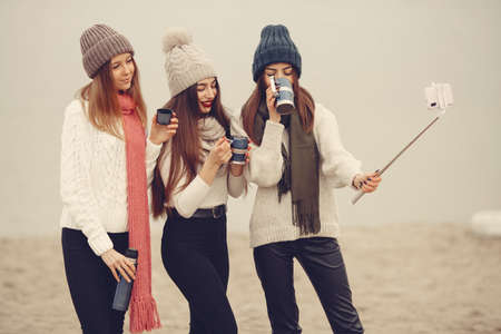 Women in a winter park without snow with bottle and teaの写真素材