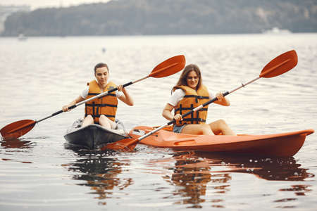 Women paddling on a lake in a kayakの写真素材