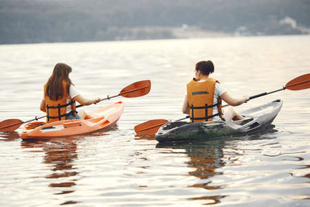 Women paddling on a lake in a kayakの写真素材