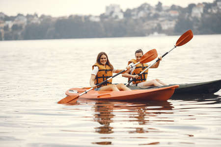 Women paddling on a lake in a kayakの写真素材