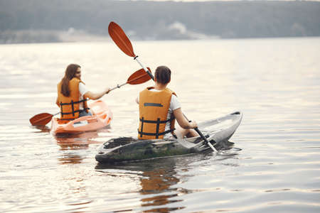 Women paddling on a lake in a kayakの写真素材
