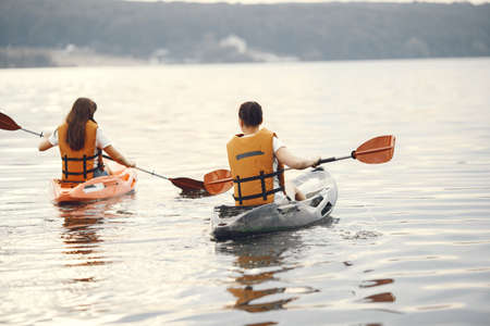 Women paddling on a lake in a kayakの写真素材
