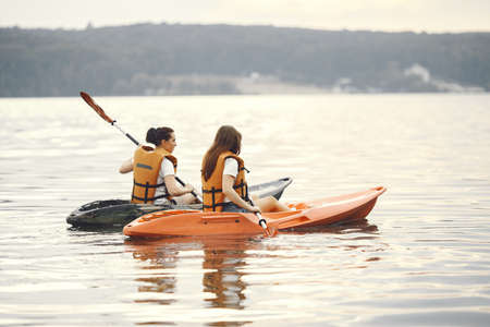 Women paddling on a lake in a kayakの写真素材