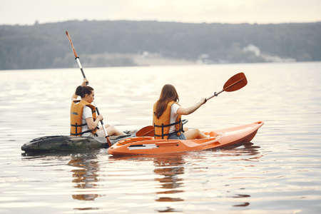 Women paddling on a lake in a kayakの写真素材
