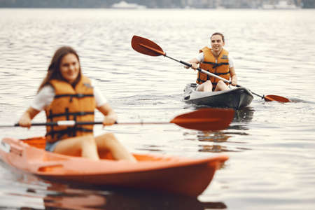 Women paddling on a lake in a kayakの写真素材