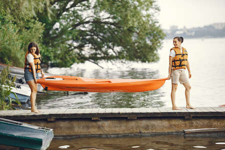 Women prepare to paddling on a lake in a kayakの写真素材