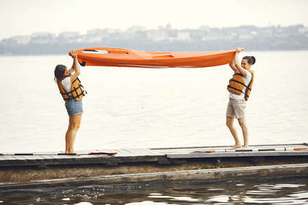 Women prepare to paddling on a lake in a kayakの写真素材