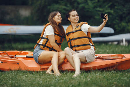 Women prepare to paddling on a lake in a kayakの写真素材