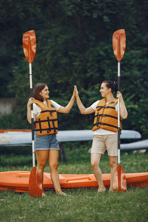 Women prepare to paddling on a lake in a kayakの写真素材