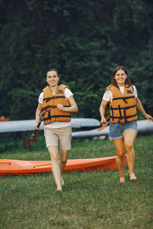 Women prepare to paddling on a lake in a kayakの写真素材